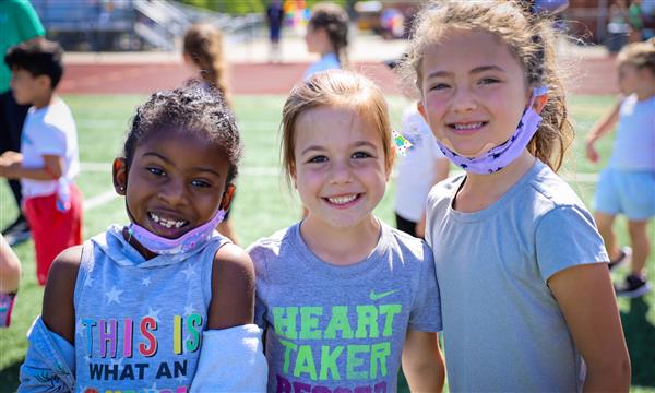Three girls smile